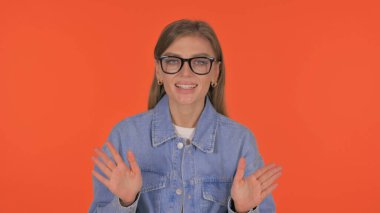 Talking Casual Young Woman Doing Video Chat on Orange Background, Portrait clipart