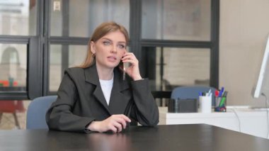 Young Businesswoman Talking on phone in Office