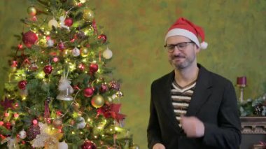 Mutlu Adam Noel ağacının yanında dans ediyor.