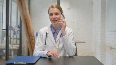 Young Doctor Talking on Phone in Clinic