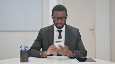 İş Adamı Masasında Akıllı Telefon Kullanıyor