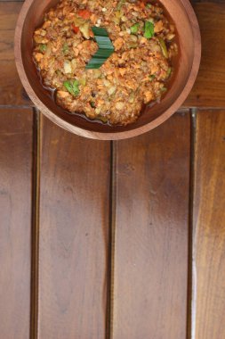 a close up Rujak Bebek or smashed fruit which is made from raw fruit crushed in a mortar and pestle and added with shrimp paste, chili and brown sugar. Indonesian traditional food photo concept.