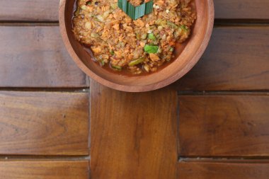 a close up Rujak Bebek or smashed fruit which is made from raw fruit crushed in a mortar and pestle and added with shrimp paste, chili and brown sugar. Indonesian traditional food photo concept.