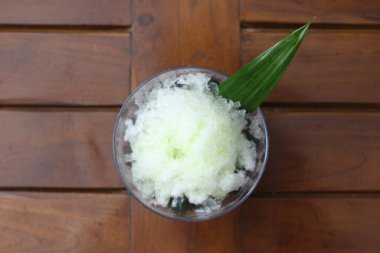 Es Kacang Merah or a cold drink made from red beans boiled with brown sugar served with coconut milk, shaved ice and covered with sweetened condensed milk chocolate and syrup. Indonesian traditional food photo concept.