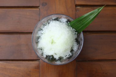 Es Kacang Merah or a cold drink made from red beans boiled with brown sugar served with coconut milk, shaved ice and covered with sweetened condensed milk chocolate and syrup. Indonesian traditional food photo concept.