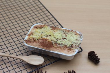 a close up of klapertart which is a typical food from Manado, Indonesia. Made from young coconut meat, sugar, flour, almonds, milk, butter, eggs, cinnamon and grated cheese. Indonesian traditional food photo concept.
