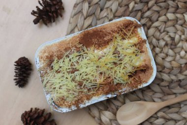 a close up of klapertart which is a typical food from Manado, Indonesia. Made from young coconut meat, sugar, flour, almonds, milk, butter, eggs, cinnamon and grated cheese. Indonesian traditional food photo concept.