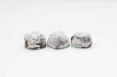 a close up of chocolate flavored mochi isolated on white background.