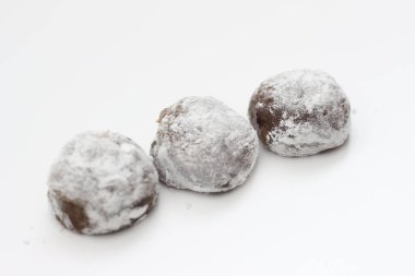 a close up of chocolate flavored mochi isolated on white background.