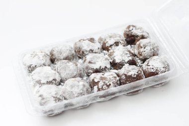 a close up of chocolate flavored mochi isolated on white background.