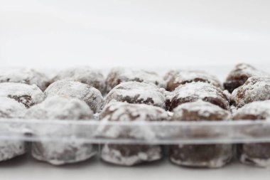 a close up of chocolate flavored mochi isolated on white background.