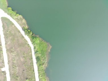aerial top-down view of Dahamilnuris lake on sunny day.
