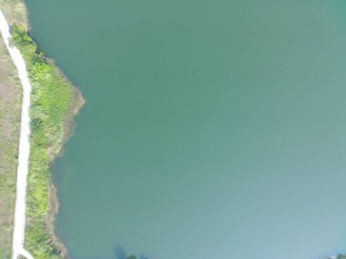 aerial top-down view of Dahamilnuris lake on sunny day.