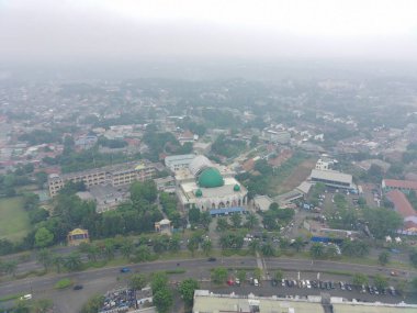 aerial view of the Darusalam mosque on the side of the highway.