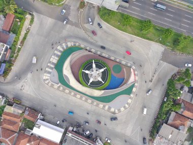 aerial view of Tugu Pancakarsa in the morning at the crossroads side by side with the toll road.