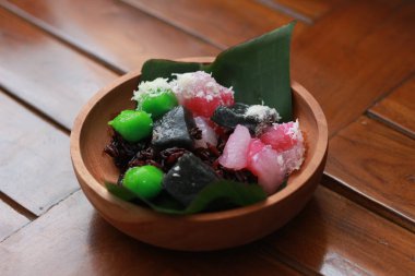 a close up of a traditional Indonesian food called Cenil. has a bright color and chewy texture with the addition of grated coconut and sugar. Indonesian traditional food photo concept.