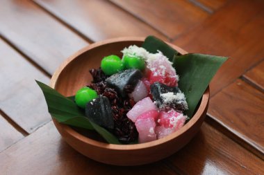 a close up of a traditional Indonesian food called Cenil. has a bright color and chewy texture with the addition of grated coconut and sugar. Indonesian traditional food photo concept.