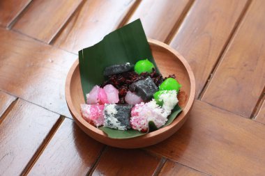 a close up of a traditional Indonesian food called Cenil. has a bright color and chewy texture with the addition of grated coconut and sugar. Indonesian traditional food photo concept.