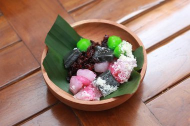 a close up of a traditional Indonesian food called Cenil. has a bright color and chewy texture with the addition of grated coconut and sugar. Indonesian traditional food photo concept.