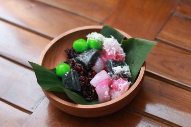 a close up of a traditional Indonesian food called Cenil. has a bright color and chewy texture with the addition of grated coconut and sugar. Indonesian traditional food photo concept.