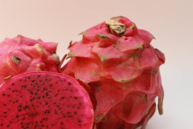 a close up of red dragon fruit isolated on white background. healthy food concept photo. fresh and sweet fruit.