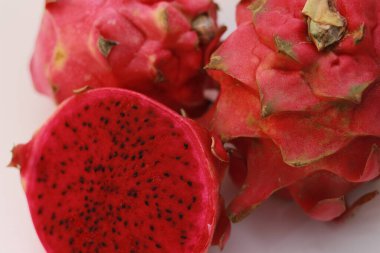 a close up of red dragon fruit isolated on white background. healthy food concept photo. fresh and sweet fruit.