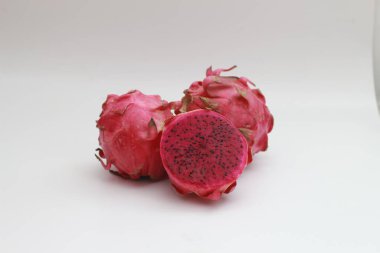 a close up of red dragon fruit isolated on white background. healthy food concept photo. fresh and sweet fruit.