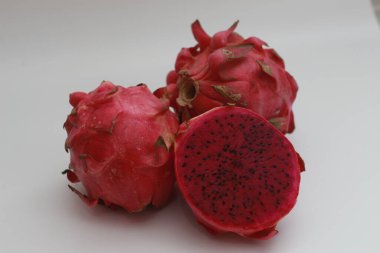 a close up of red dragon fruit isolated on white background. healthy food concept photo. fresh and sweet fruit.