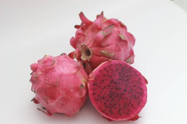 a close up of red dragon fruit isolated on white background. healthy food concept photo. fresh and sweet fruit.