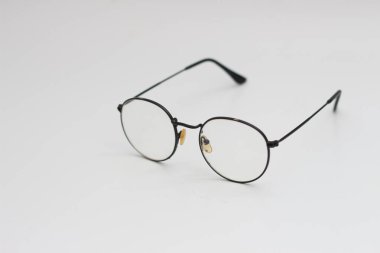 a close up of eyeglasses with black frames isolated on white background