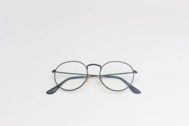 a close up of eyeglasses with black frames isolated on white background