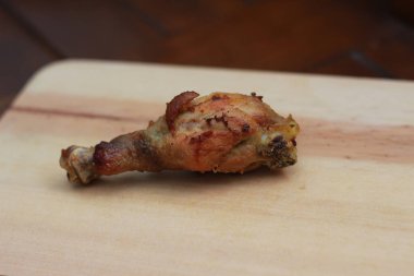 a close up of fried chicken thighs on a wooden cutting board. Indonesian food photo concept.