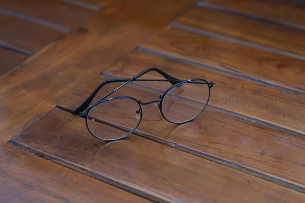 Close Eyeglasses Black Frames Isolated Natural Patterned Wooden Background — Stok fotoğraf