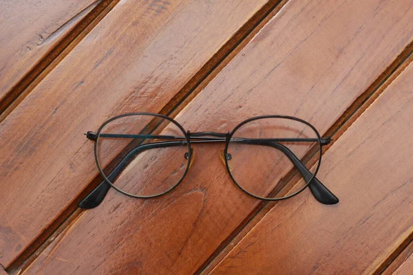Close Eyeglasses Black Frames Isolated Natural Patterned Wooden Background — 图库照片