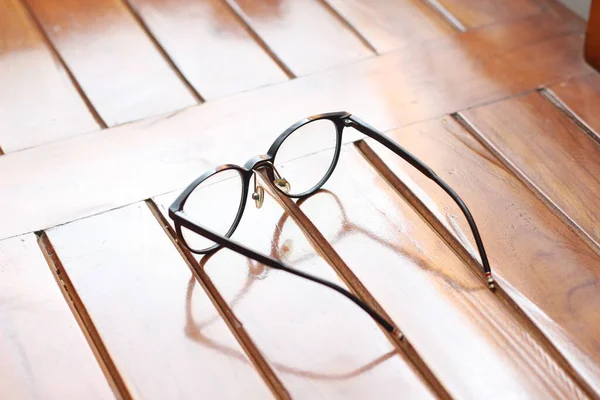 Close Eyeglasses Black Frames Isolated Natural Patterned Wooden Background — Zdjęcie stockowe