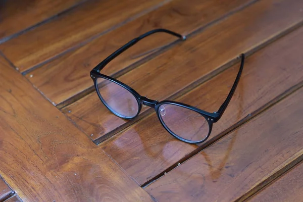 Close Eyeglasses Black Frames Isolated Natural Patterned Wooden Background — Stock Photo, Image