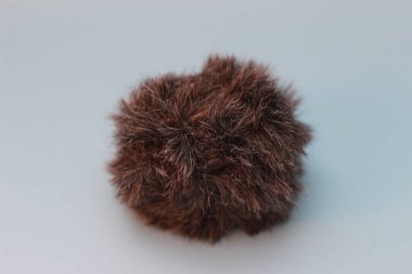 a close up of a cat fur shaped microphone silencer. audio visual work equipment concept.