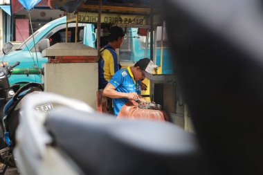 shoe sole worker repairing shoes at a roadside stand. a unique profession from Indonesia.