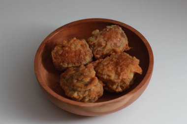 a close up of a bowl of fried stuffed tofu isolated on white background. Indonesian food concept.