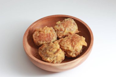 a close up of a bowl of fried stuffed tofu isolated on white background. Indonesian food concept.