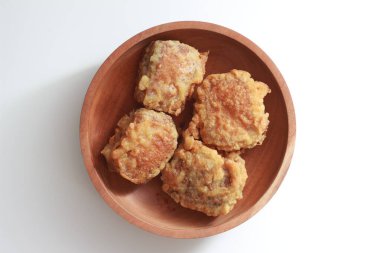 a close up of a bowl of fried stuffed tofu isolated on white background. Indonesian food concept.