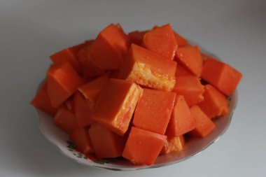Papaya slices served on a white plate isolated on a white background. concept of healthy food for body digestion.