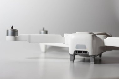 a close up of detailed white drone parts isolated on white background. drone camera photo concept.