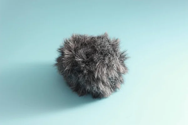 a close up of a cat fur shaped microphone silencer. audio visual work equipment concept.