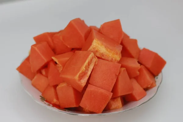 Papaya slices served on a white plate isolated on a white background. concept of healthy food for body digestion.
