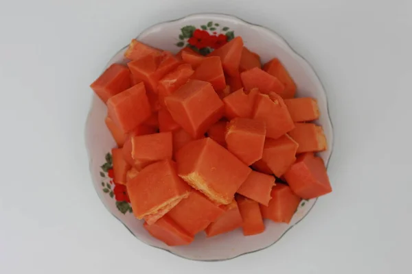 Papaya slices served on a white plate isolated on a white background. concept of healthy food for body digestion.