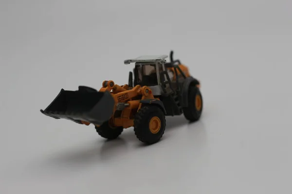 Close Miniature Orange Wheel Loader Toy Isolated White Background Concept — Fotografia de Stock