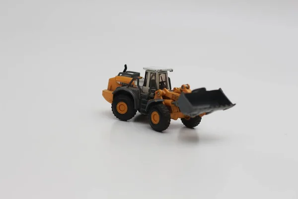 Close Miniature Orange Wheel Loader Toy Isolated White Background Concept — Fotografia de Stock