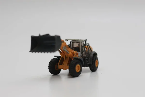 Close Miniature Orange Wheel Loader Toy Isolated White Background Concept — Stok fotoğraf