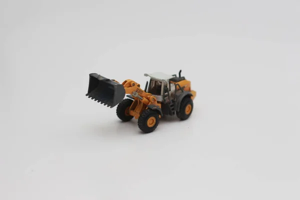Close Miniature Orange Wheel Loader Toy Isolated White Background Concept — Zdjęcie stockowe